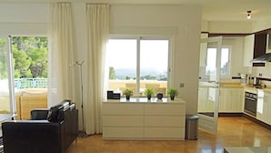 A modern living room with a sofa, a coffee table, and a view of the outdoors. - Casa Casaert - Altea, Costa Blanca (Altea)