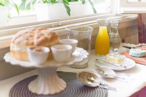 A breakfast table with pastries, a glass of orange juice, and a butter dish. - One of our top Picks in Pretoria - Lovely Spacious Room With Breakfast (Pretoria)