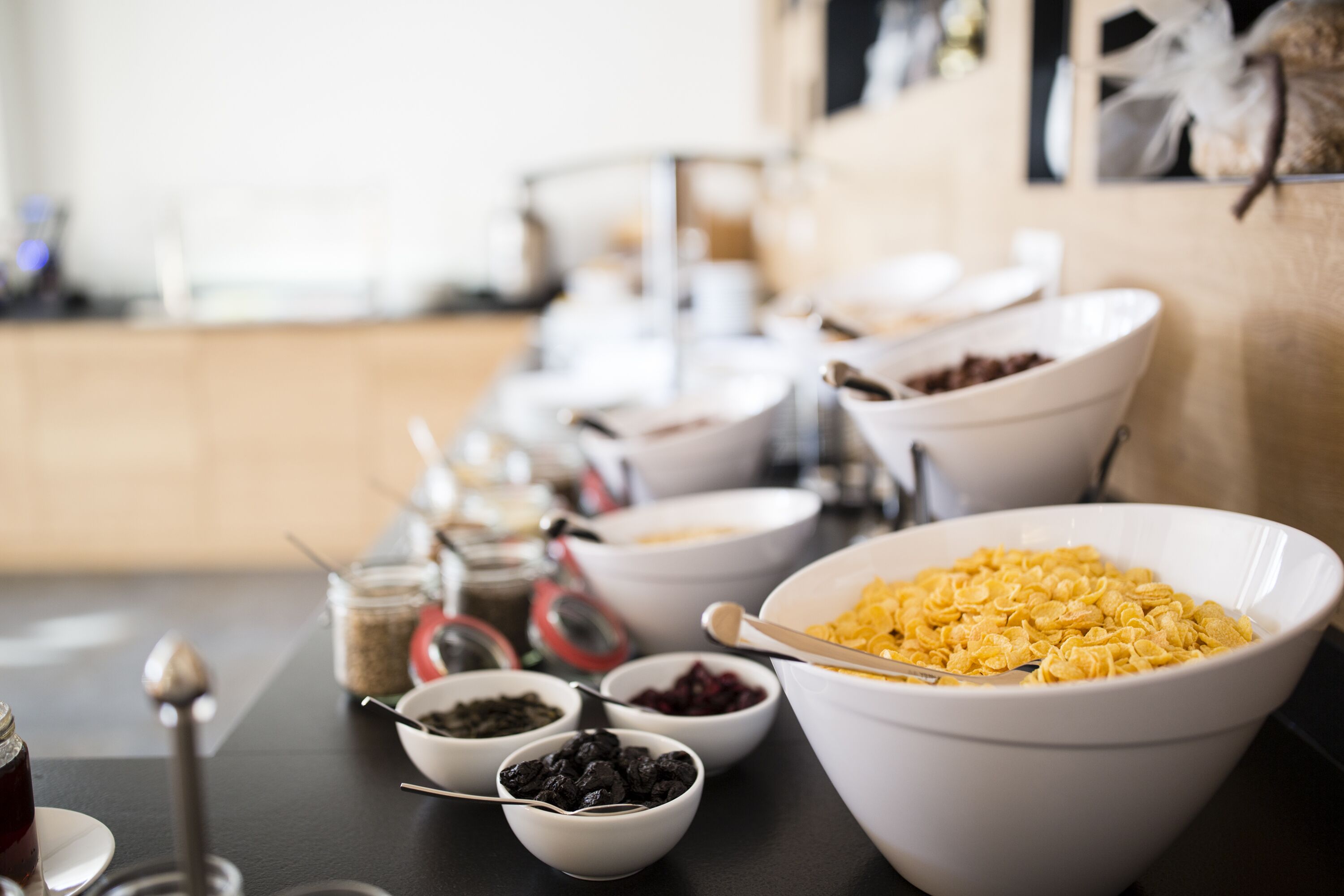 A buffet table with various food items and condiments.