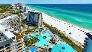 A resort with a large pool area, beachfront, and multiple high-rise buildings. - Edgewater Windward B-105 (Panama City Beach)