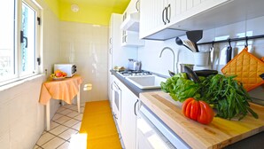 A kitchen with white cabinets, a yellow ceiling, and a window. - Palazzo Rocco - Villa Red Moon in Love - 1 Room - 1 bath - 4 person - Sea 500 mt (Praiano)