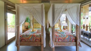 A room with two wooden four-poster beds with white canopies, colorful bedding, and bedside lamps. - Artful 3bed3bath Villa And Bungalow in the Rice Fieldsbest Breakfast in Bali (Ubud)