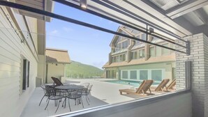 A modern house with a pool, outdoor furniture, and a view of a mountain. - Modern Magic At Park City Base Studio Bedroom Condo by RedAwning (Park City)