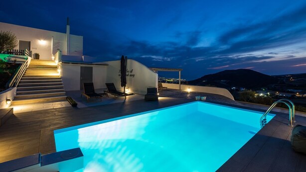A modern pool area with a clear view of the surrounding landscape and a staircase leading to an upper level. - Villa Amphitrite With Amazing sea View and Private Swimming Pool (Paros)
