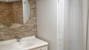 Bathtub, hair dryer, toilet paper