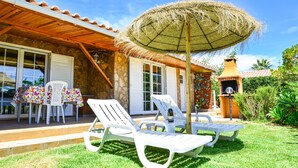 A patio with white lounge chairs, a table, and a thatched umbrella. - OFFER 2020 VILLA CLAJESSI - 4 PERSONS (Albufeira)