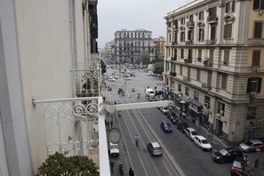 A street view from a balcony overlooking a busy urban street with buildings and vehicles. - Room in B&B - 1 bed in Basic 8 Bed Mixed Dorm - Shared Bathroom (Naples)