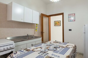 Basic Apartment, 2 Bedrooms | Private kitchen | Full-sized fridge, oven, stovetop, cookware/dishes/utensils
