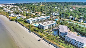 A coastal hotel with multiple buildings, a beach, and a view of the sea. - Savannah Beach & Racquet Club 303A (Tybee Island)