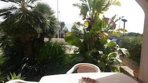Relax in a serene outdoor seating area surrounded by lush greenery and a tranquil atmosphere.