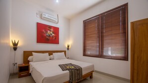 A bedroom with a wooden bed, white bedding, a red abstract painting, and a window with blinds. - Lombok From Your Private Villa Sepuluh (Senggigi)