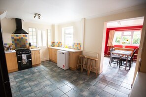 Enjoy meals in the kitchen with a stove, oven, and dishwasher, adjacent to a dining area with a table and chairs.