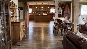 A spacious kitchen with wooden cabinets, a central island, and pendant lighting. - Private Peaceful Country Getaway - Family Friendly - Illinois (Berwick)