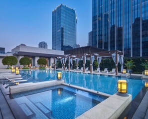 A rooftop pool with lounge chairs, a pergola, and cityscape views. - ANDAZ XIAMEN, BY HYATT (Xiamen)