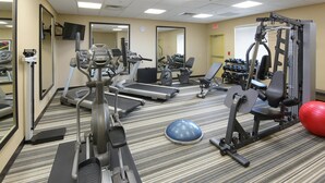 A gym with treadmills, elliptical machines, a weight bench, dumbbells, and a red exercise ball. - Candlewood Suites Odessa Midland by IHG (Odessa)