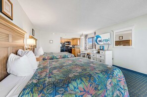 A hotel room with two beds, a kitchenette, a dining area, and a view of the ocean. - Oceanview Studio at Compass Cove with Pools,Updated! (Myrtle Beach)