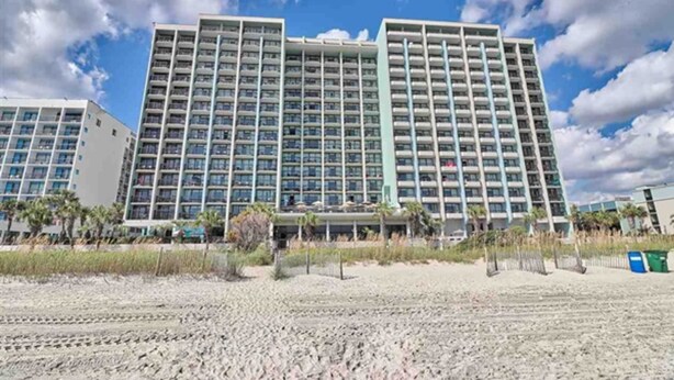 A multi-story hotel with a modern architectural design, featuring balconies and a beach view. - Oceanview Studio at Compass Cove with Pools,Updated! (Myrtle Beach)