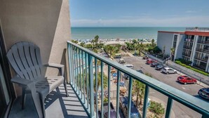 A balcony with a view of a beach, parking area, and a building with balconies. - Sand Dunes Resort, Ocean View Getaway, 5th  Floor! (Myrtle Beach)
