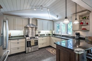 Kylskåp, grytor/köksredskap, kryddor och matbord