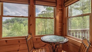 A wooden cabin with large windows offering a forest view. - Property not available (Vilas)