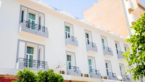 A multi-story hotel with balconies, large windows, and a flat facade. - Hotel Olympic (Fes)