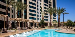 A resort pool area with lounge chairs and palm trees, and text indicating no resort fee and free parking onsite. - Luxury one bedroom with full kitchen + amenities . (Las Vegas)