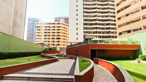 A modern building with a central courtyard, surrounded by high-rise apartments. - Excellent fit 2 bedrooms fully furnished, cable TV, sea view from the balcony (CE)
