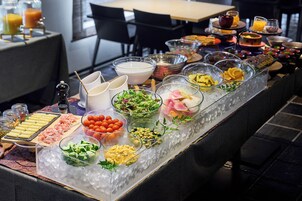 A buffet with various food items and beverages.
