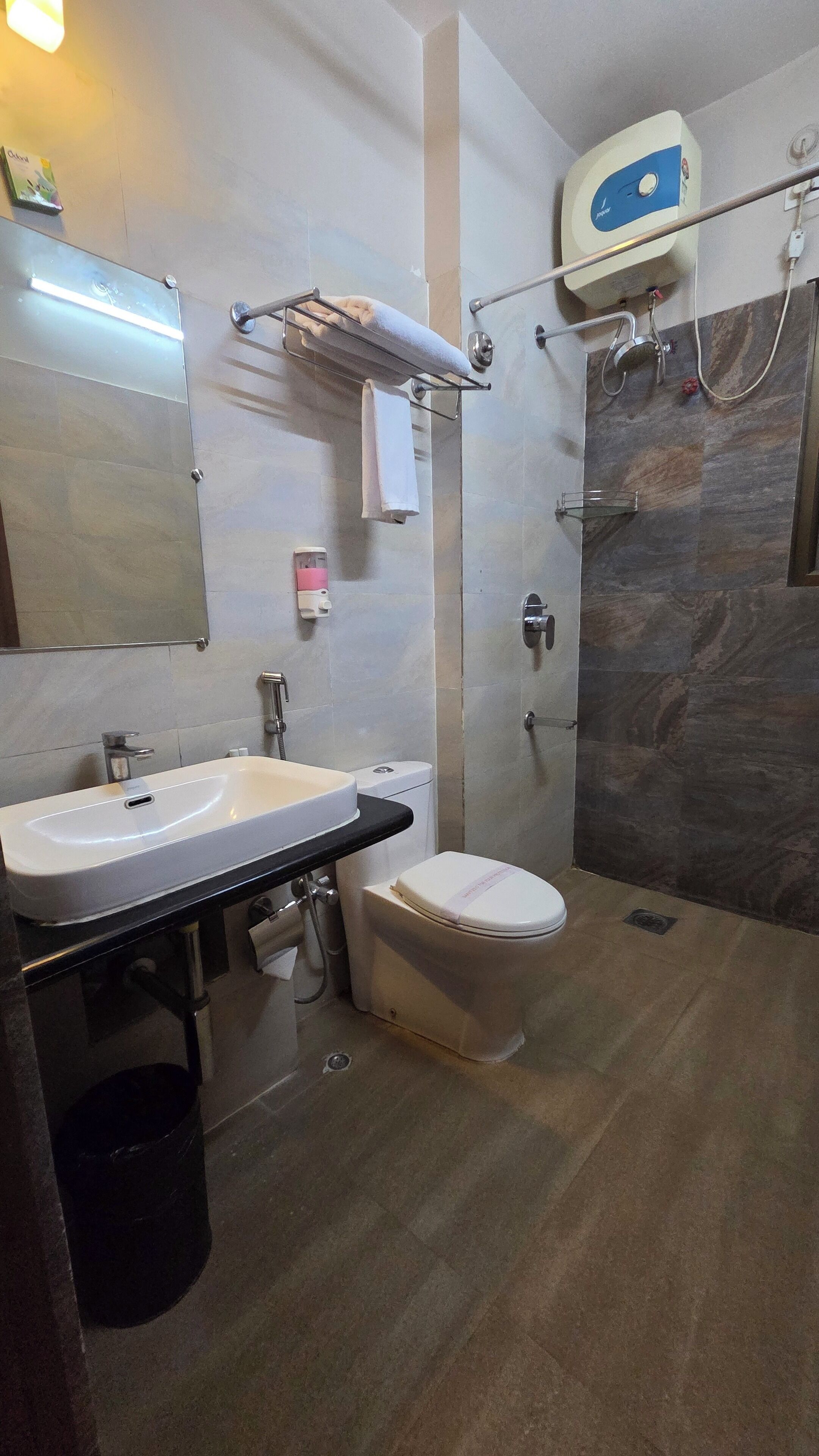 A modern bathroom with a sink, toilet, and shower.