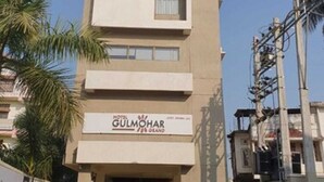 A hotel named 'Gulmohar' with a modern architectural design, featuring a flat facade and a central entrance. - Hotel Gulmohar Grand (East Jorhat)