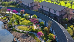 A residential area with houses, a curved pathway, and a water feature.
