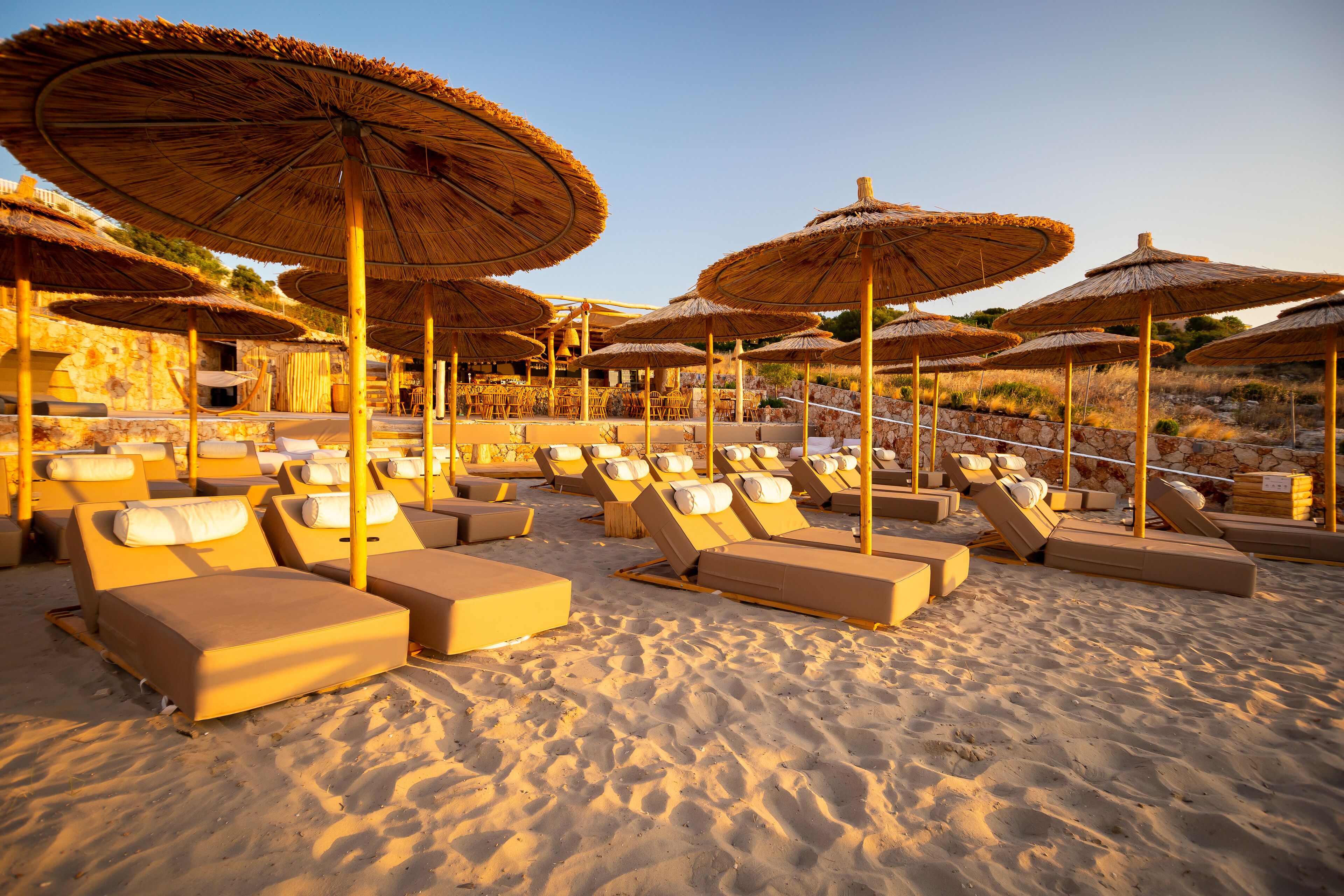 on the beach, white sand, sun-loungers, beach bar