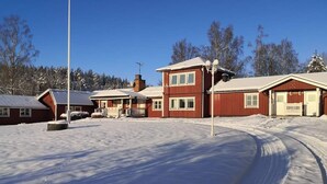 Un barrio residencial cubierto de nieve, con casas y cielo despejado.