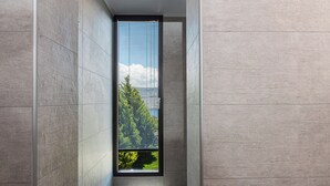 A narrow hallway with a large window. - Luxury Ensuite Villa Overlooking Souda Bay (Chania)