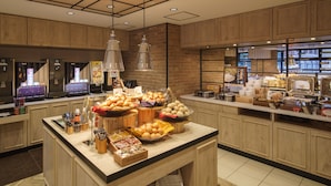 A buffet area with various food items and a coffee station. - Super Hotel Yokohama Kannai (Yokohama)