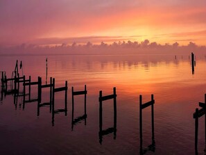A calm lake at sunrise with wooden docks extending into the water. - 4 Star Holiday Home in Faaborg (Faaborg)