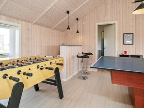 A room with a foosball table, a ping pong table, and two bar stools. - Holiday Home in HarboÃ¸re (Harboore)
