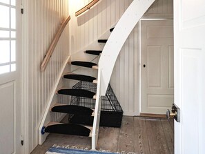A staircase with a white railing and black steps leading to a door. - 4 Star Holiday Home in Skillingaryd (Skillingaryd)