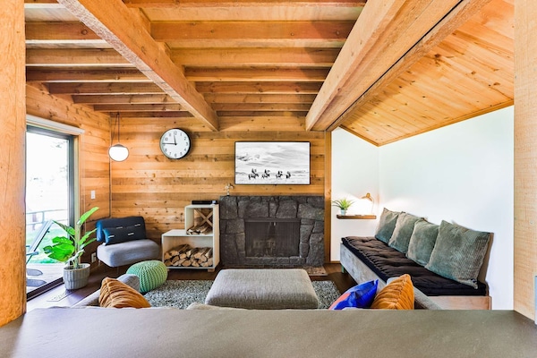Cozy living space with wood burning fireplace and new furniture