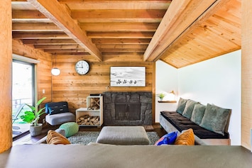 Cozy living space with wood burning fireplace and new furniture