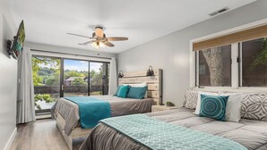 A bedroom with two beds, a ceiling fan, a window with a view, and a sliding glass door to the outside. - Knolls 0424 - Three Bedroom Apartment, Sleeps 8 (Osage Beach)