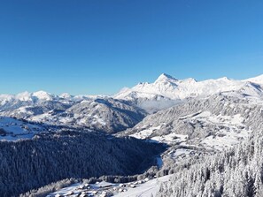 A snow-covered mountain landscape with a clear sky.