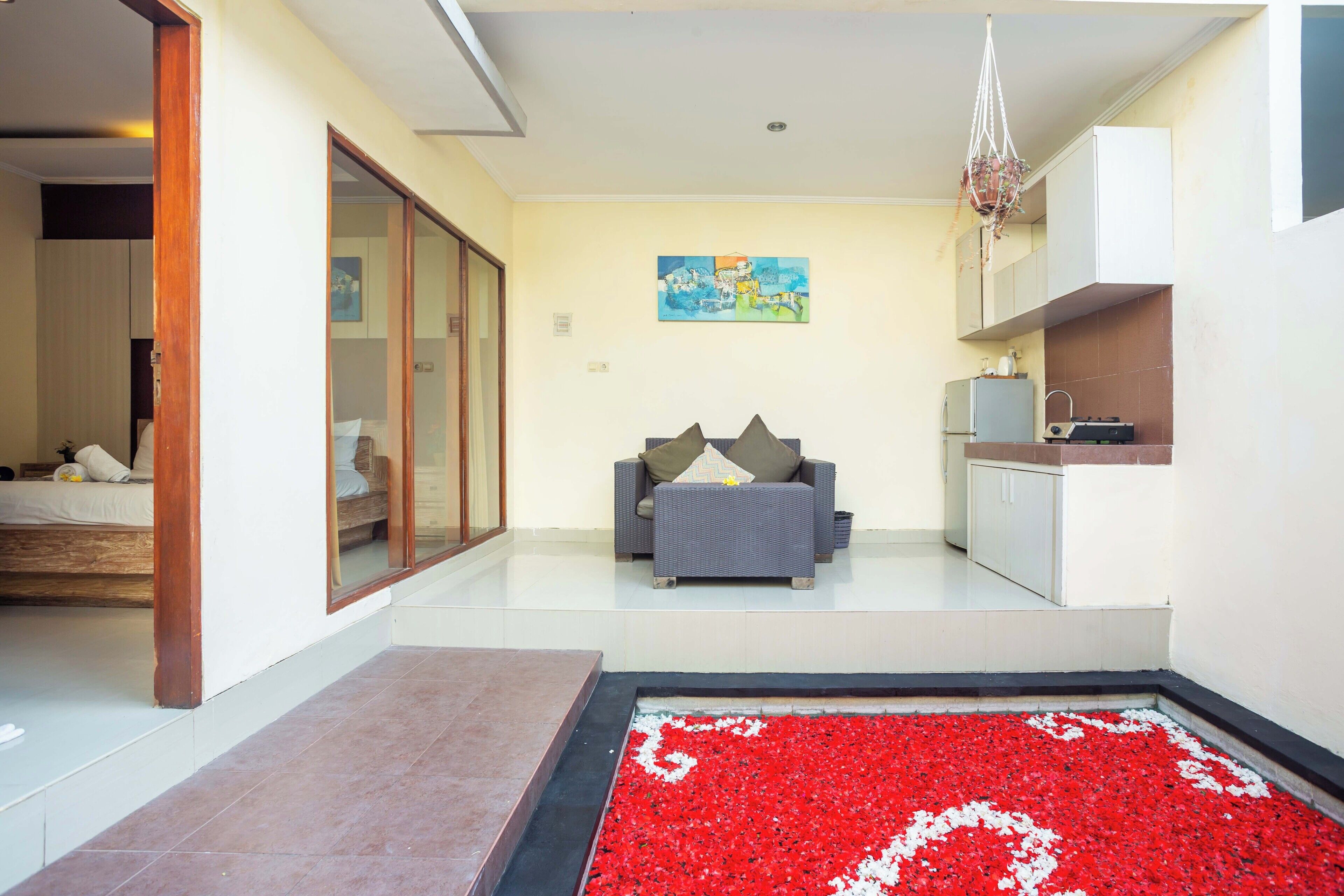 A modern living area with a sofa, a dining table, and a kitchen area.
