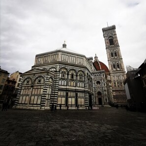 A historic building with intricate architectural details and a prominent tower. - Florence Hostels Anamaria (Florence)