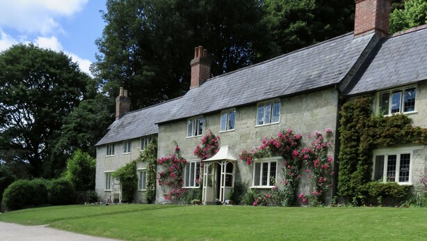 A stone building with a sign indicating a garden.