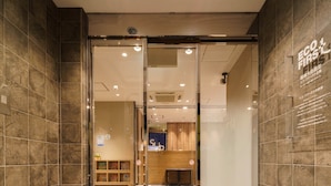 A hotel entrance with a glass door, tiled walls, and a reception desk visible inside. - Super Hotel Tokyo JR Kamata Nishiguchi (Tokyo)