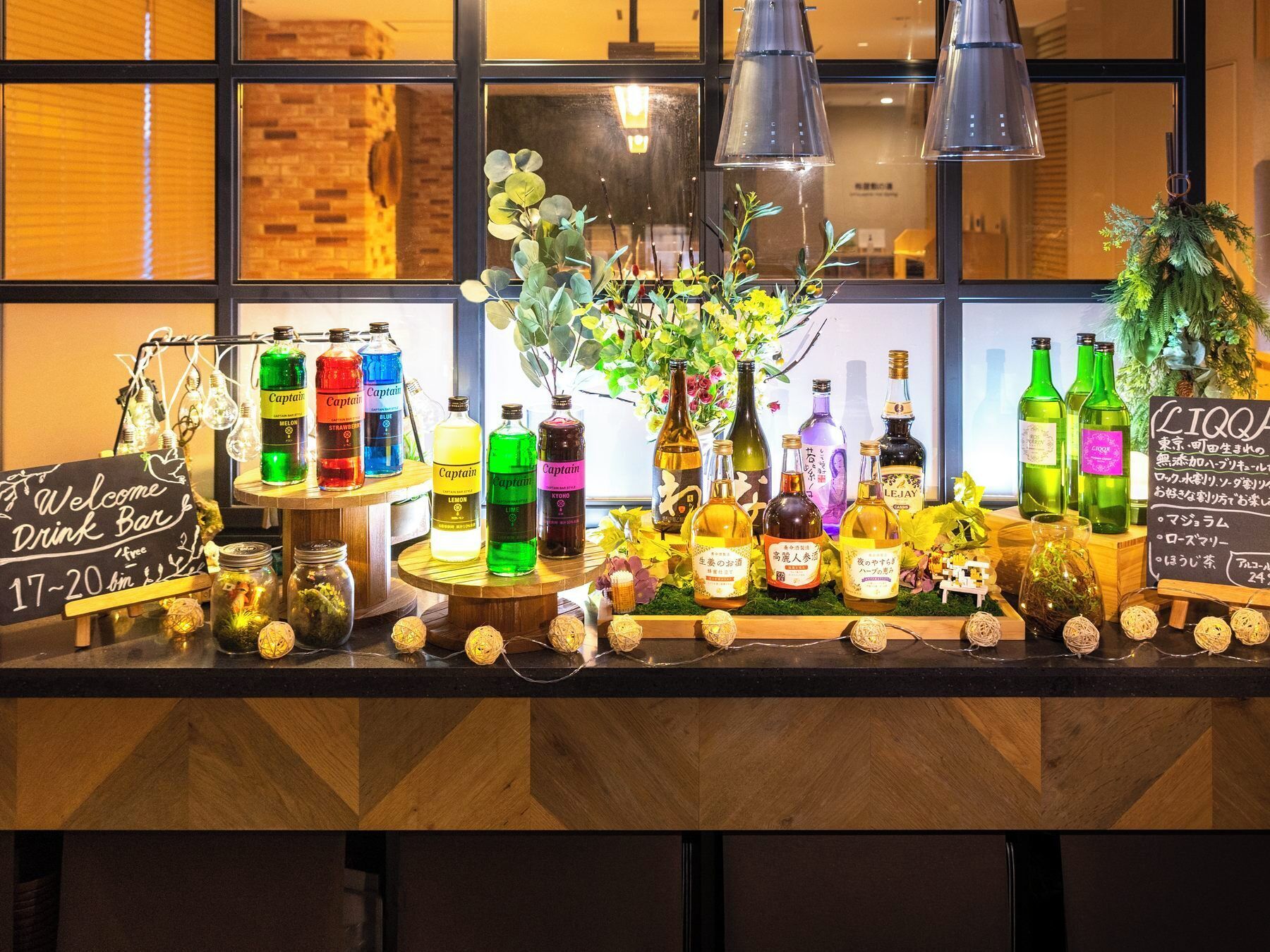 A bar area with various bottles and a sign indicating a drink bar.