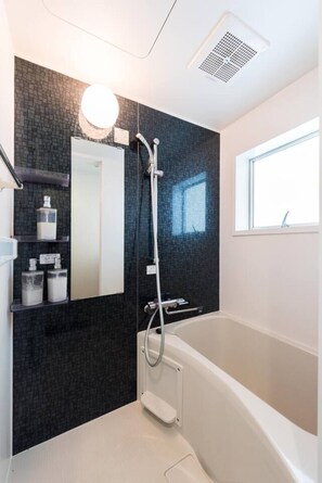 Separate tub and shower, deep soaking tub, hair dryer, towels