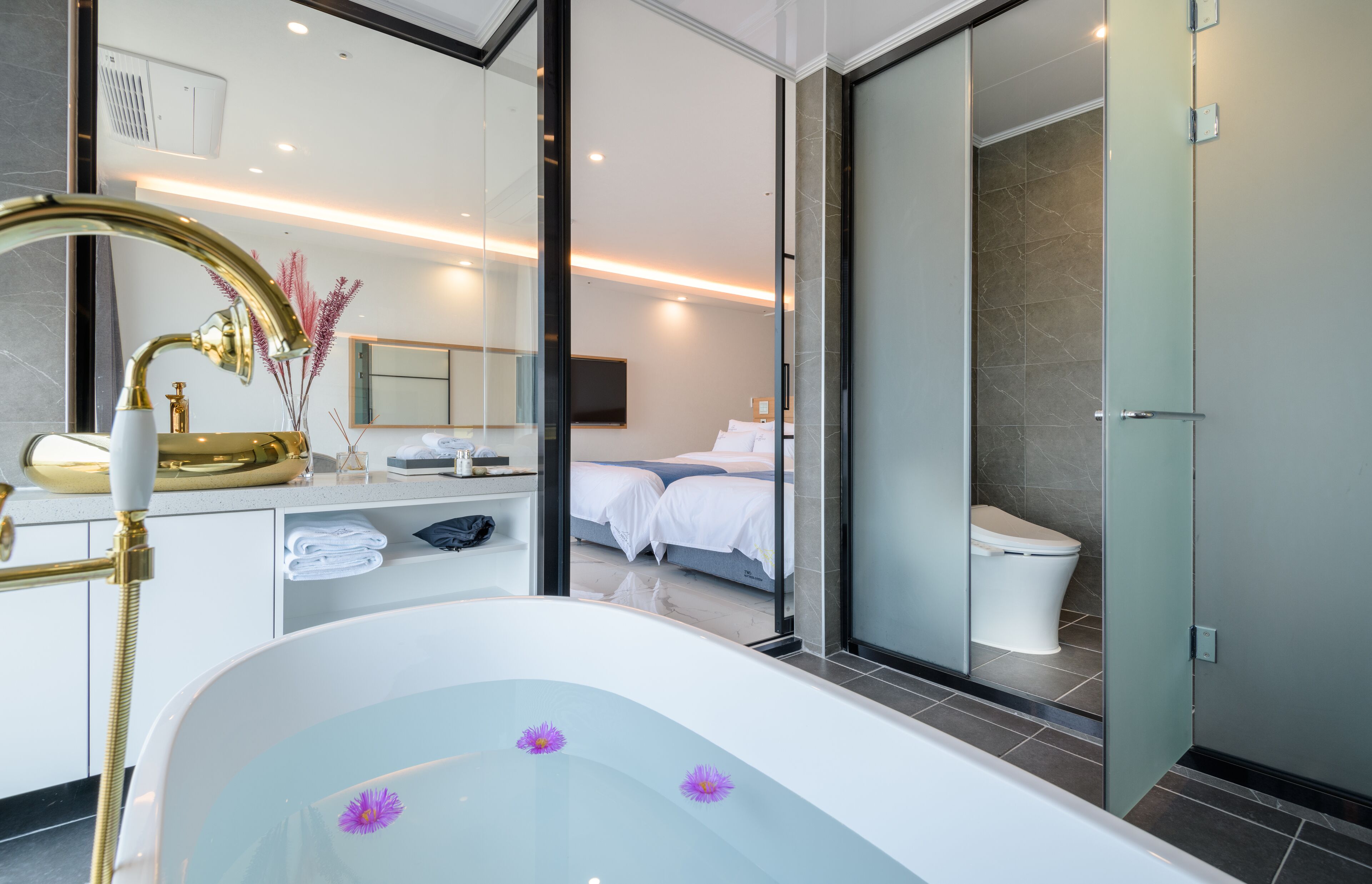 family studio suite | bathroom | designer toiletries, hair dryer, slippers, bidet