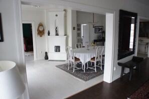 Enjoy meals in this elegant dining area with a chandelier, large mirror, and comfortable seating for four.